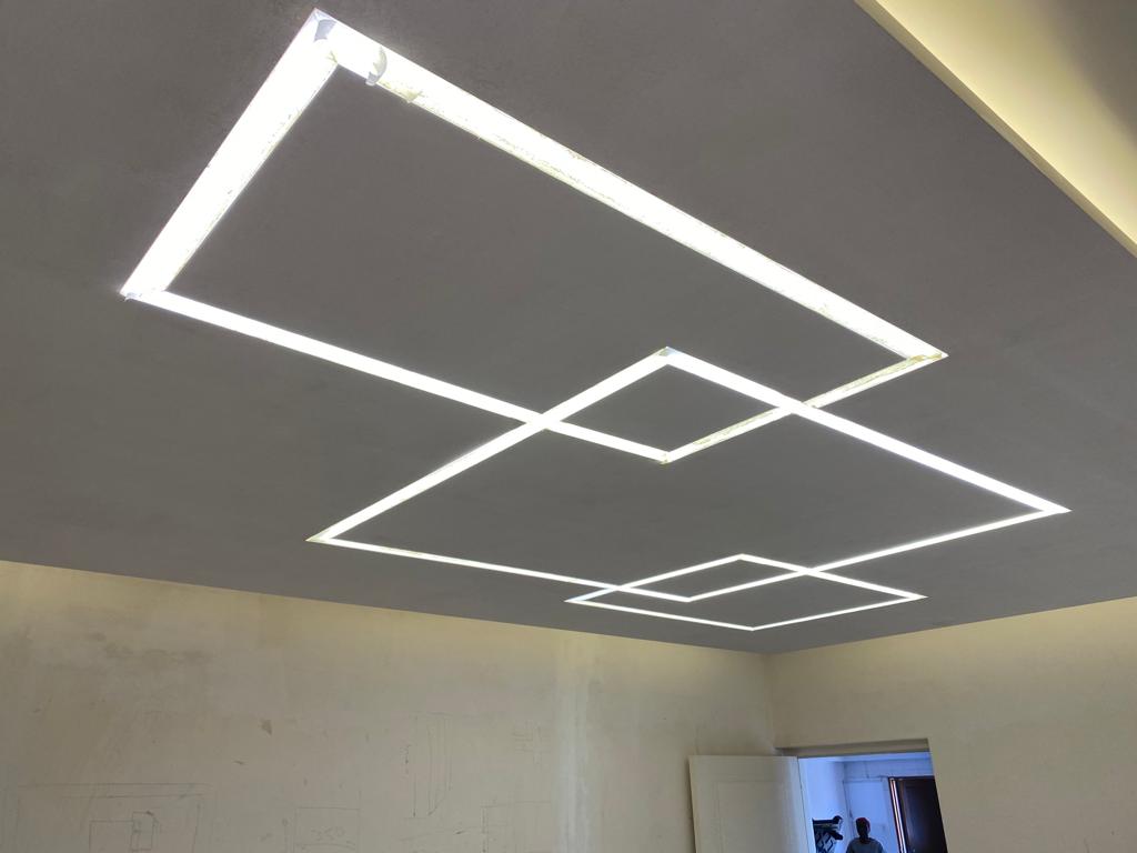 Finished ceiling panels with integrated lighting